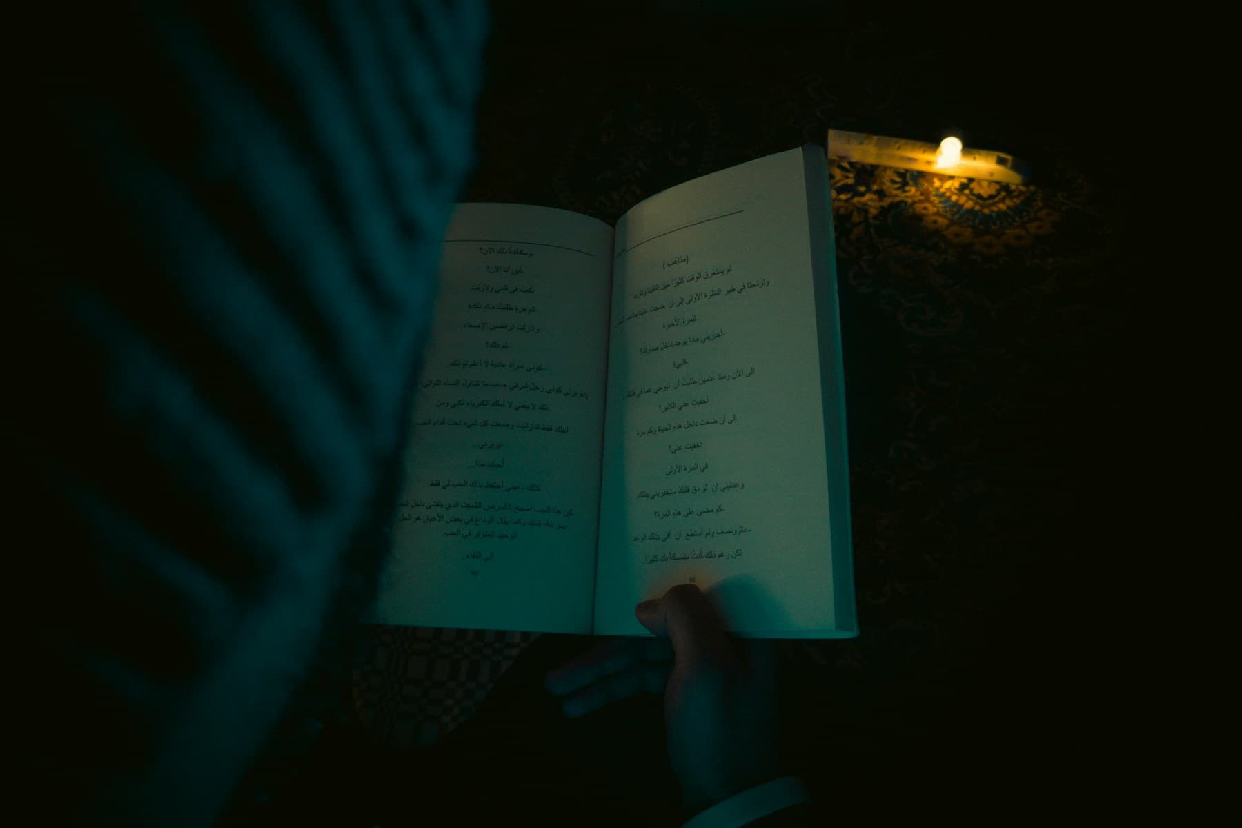 Open book in warm candlelit study light